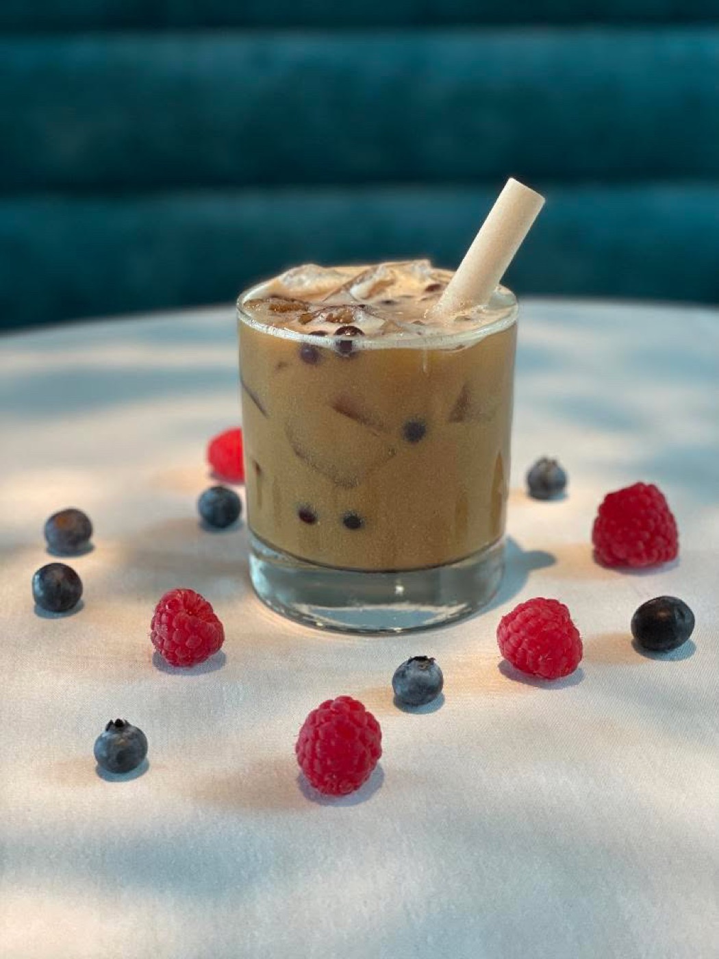 Boba After Hours poured over ice with fresh berries